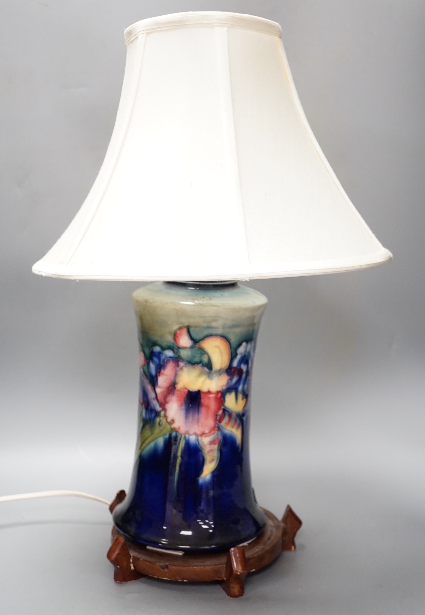 A Moorcroft orchid pattern lamp base with shade and later stand 30cm